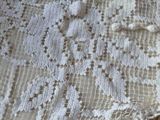 a white lace angel on a table with a brown teddy bear