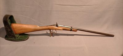 a close up of a rifle with a wooden handle on a white background