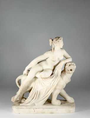a white marble statue of a woman on a lion
