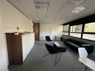 a room with a couch, chairs, and a table in it