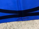 a close up of a blue scarf with black stripes on it
