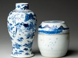 two blue and white vases sitting next to each other on a table