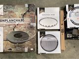 a box of bonplancha on the floor next to a box of speakers