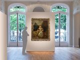 a large painting hanging on the wall in a large room