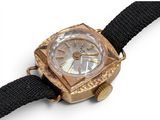 a gold watch with a black strap on a white background