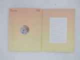 a notepad with a coin on top of it and a notepad with a coin on it