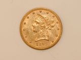 a close up of a gold coin with a woman ' s head on it