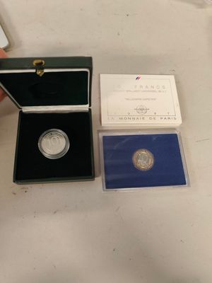 a small box with a coin inside of it on a table