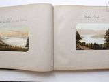 two open books with pictures of mountains and trees on them