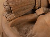 a statue of a man holding a baseball glove