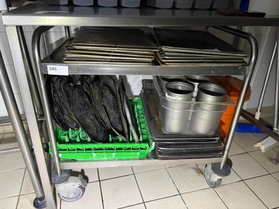 a metal cart with a bunch of pans on it