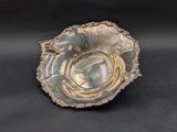 a silver bowl with a picture of a woman on it