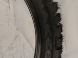 a tire on the wall next to a wall