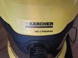 a yellow and black vacuum that is on a wooden floor
