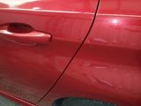a red car that is parked in a garage