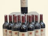 bottles of red wine lined up in a pyramid on a white surface