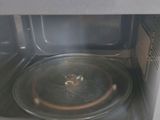 a close up of a microwave with a pan inside of it
