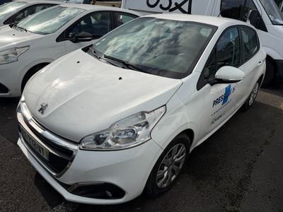 a white car parked in a lot with other cars in the background