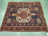 an old rug on the floor with a blue and red design