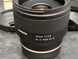 a camera lens sitting on a table next to a box