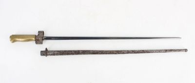 an old sword with a wooden handle on a white surface