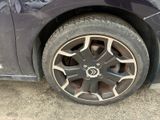 a close up of a car ' s tire on the ground
