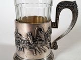 a silver cup with a horse drawn carriage on it