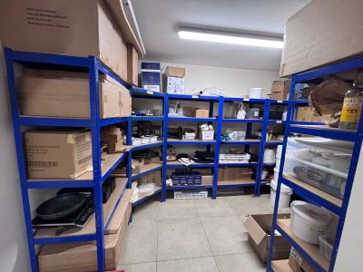 a room filled with boxes and shelves with boxes on them