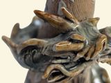 a close up of a vase with a dragon on it