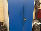 a blue cabinet in a garage with a lot of tools