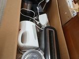 a cardboard box full of appliances and appliances on the floor