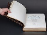a person holding a book open to show it ' s contents