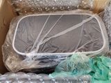 a cardboard box filled with plastic wrap and other items