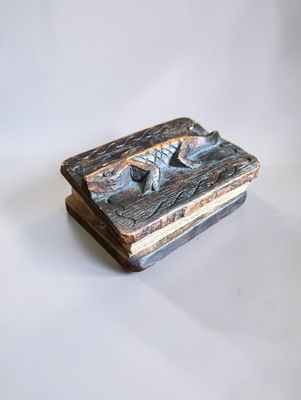 an image of a small wooden box with a bird on it