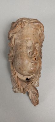 a statue of a woman ' s face on the wall