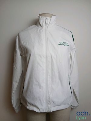 the jacket is white and has a green logo on it