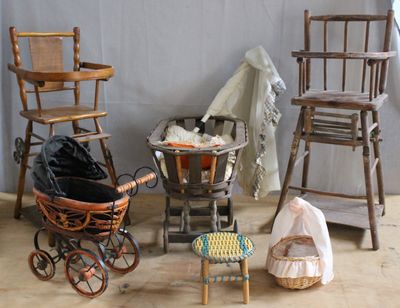 a baby ' s stroller, a chair, a chair, and a table in a room