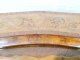 a wooden bench with a carved design on it