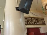 a television hanging from the ceiling of a restaurant