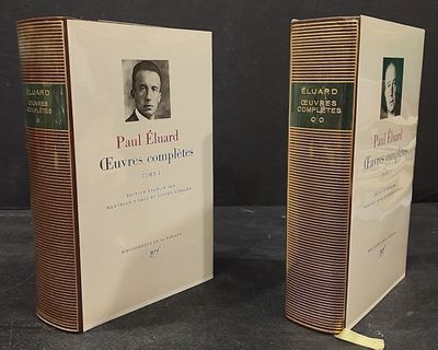two books on a table with a picture of a man in a suit