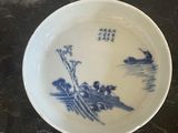 a blue and white bowl sitting on top of a table