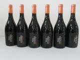 six bottles of wine lined up in a row on a table