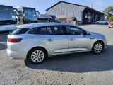 a silver car that is parked in a parking lot
