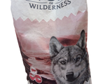 a bag of wolf wilderness dog food with a picture of a wolf on it
