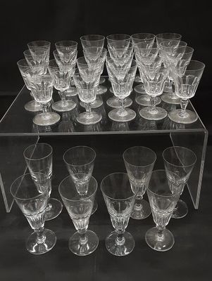 a lot of wine glasses sitting on a clear shelf