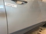 a silver car with a sticker on the side of it