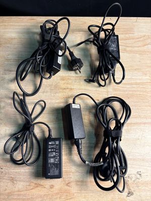 four different types of power cords and a charger on a table