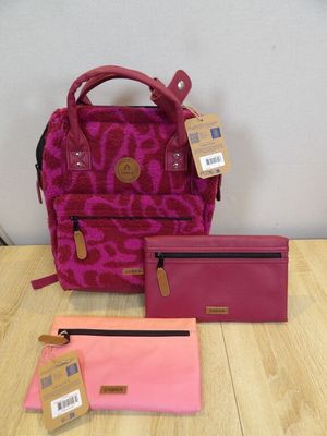 a close up of a purse and wallet on a table