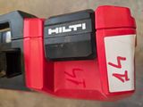 a close up of a red and black corded drill