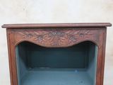 a small wooden cabinet with a shelf on top of it